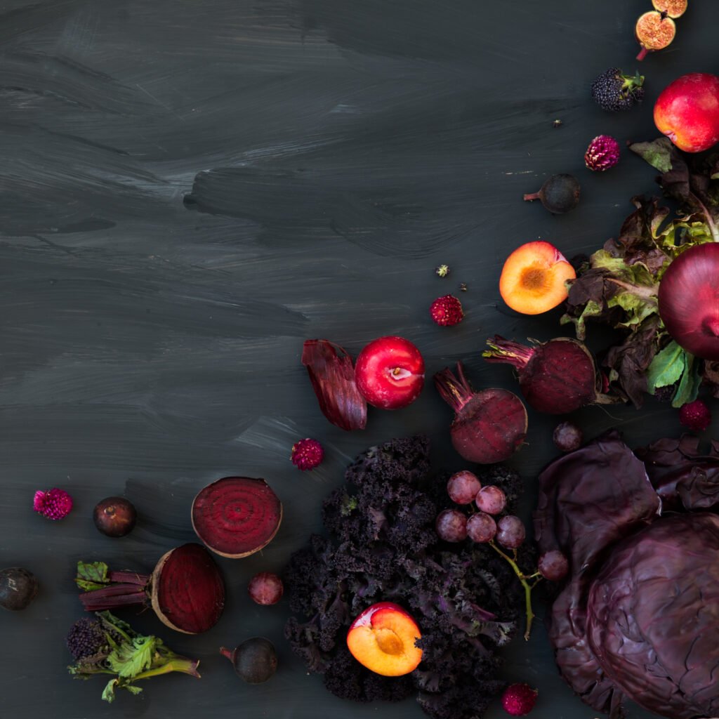 collection of fresh purple fruits and vegetables