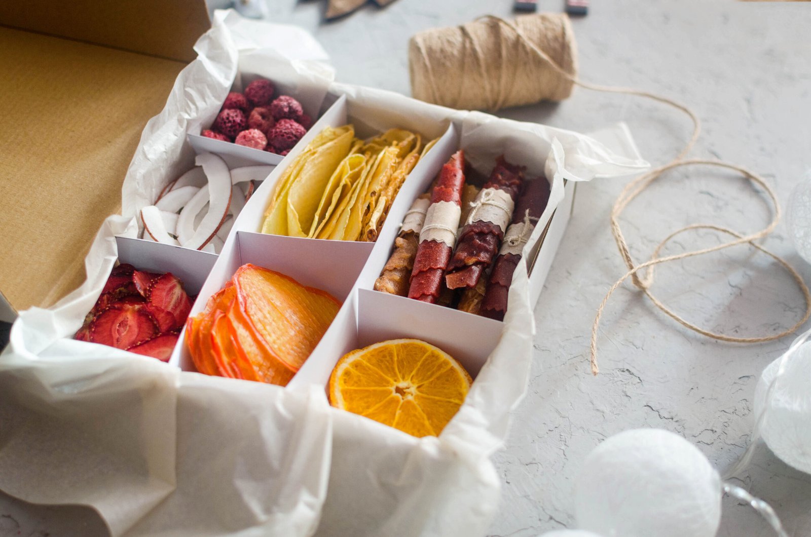 seasonal gift box with assorted dried chips on grey background.
