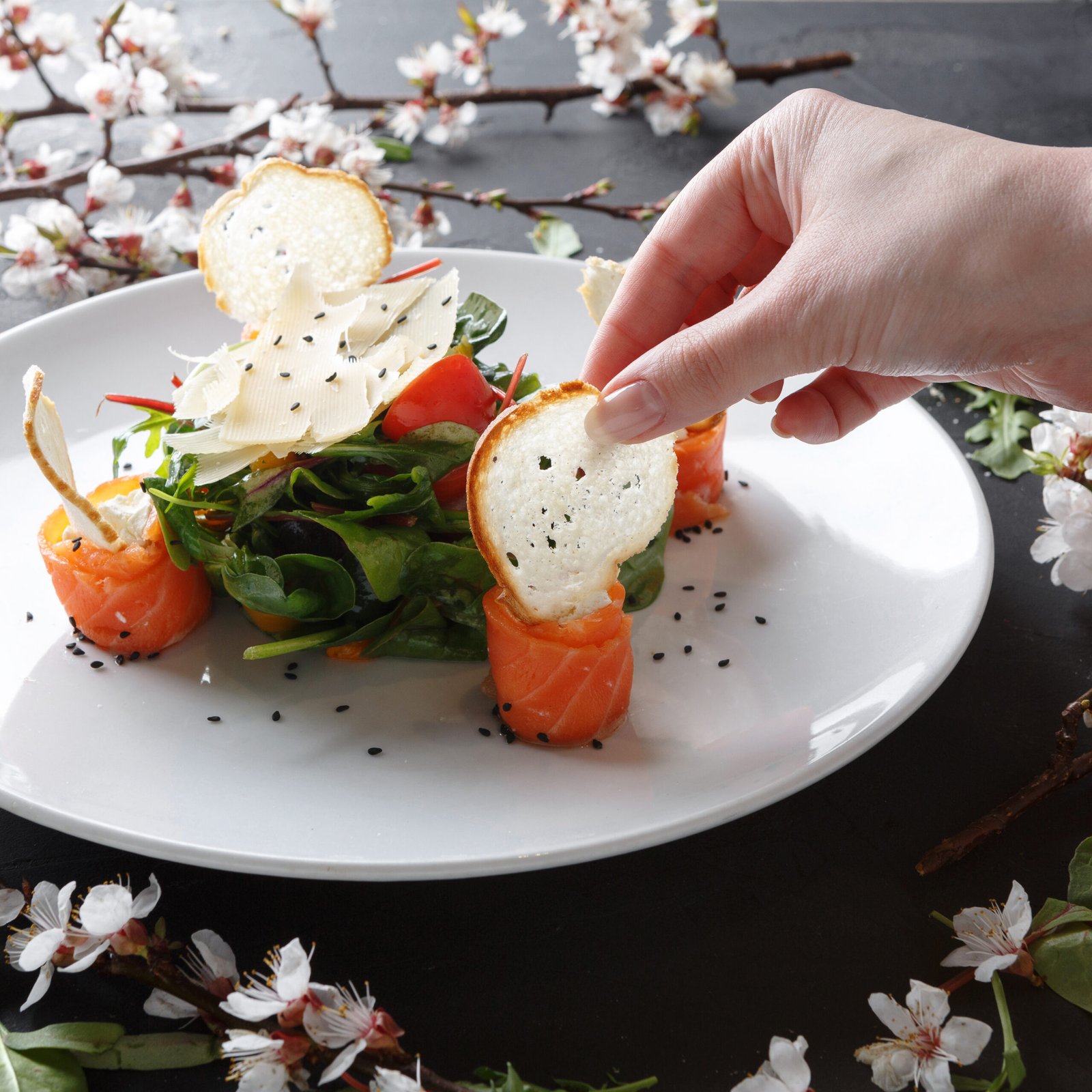 eating restaurant dish on white plate on black background, closeup