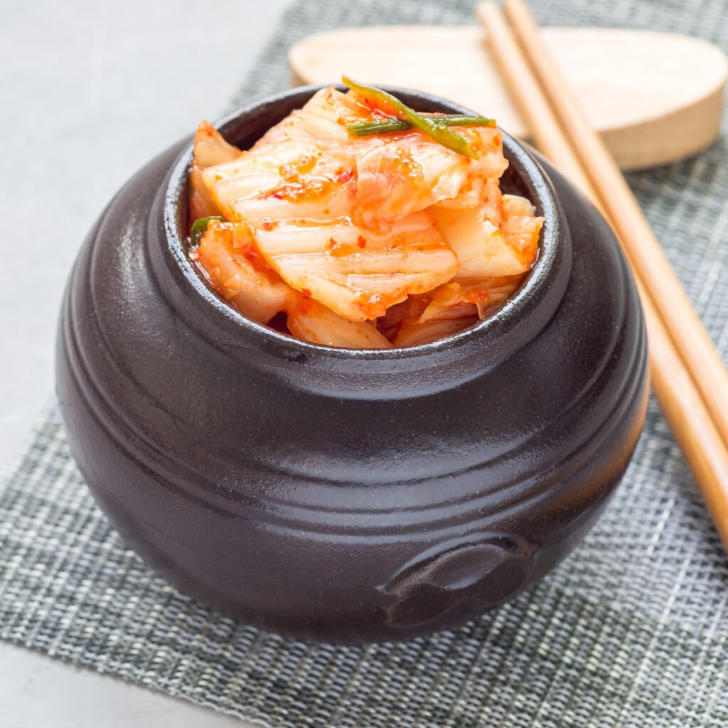 kimchi cabbage. korean appetizer in a ceramic jar, square
