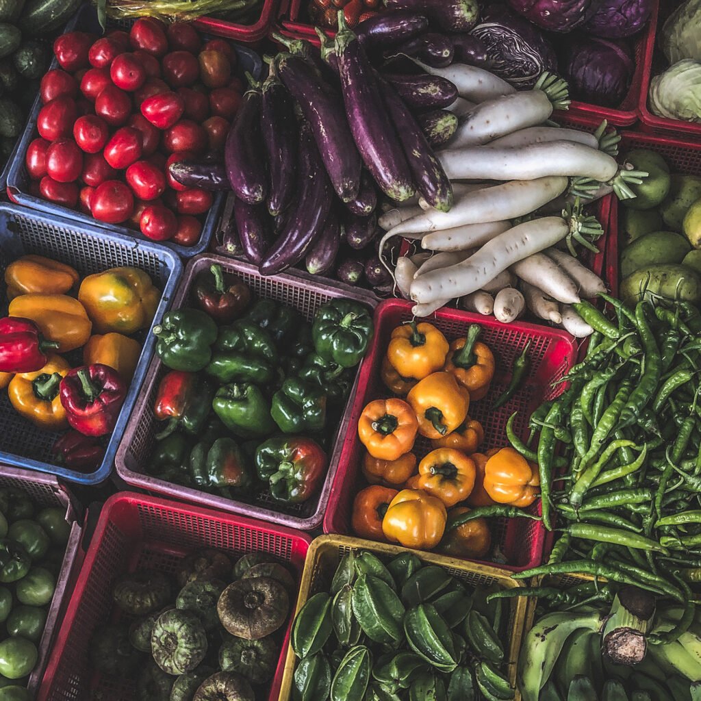 top view on a large assortment of row loose vegetables and fruits for sale in a street. short circuit production at hue market